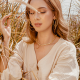 Front profile view of Carina Necklace sparkling in natural light.