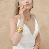 Model wearing the Casie Necklace in gold, showcasing the dome pendant.