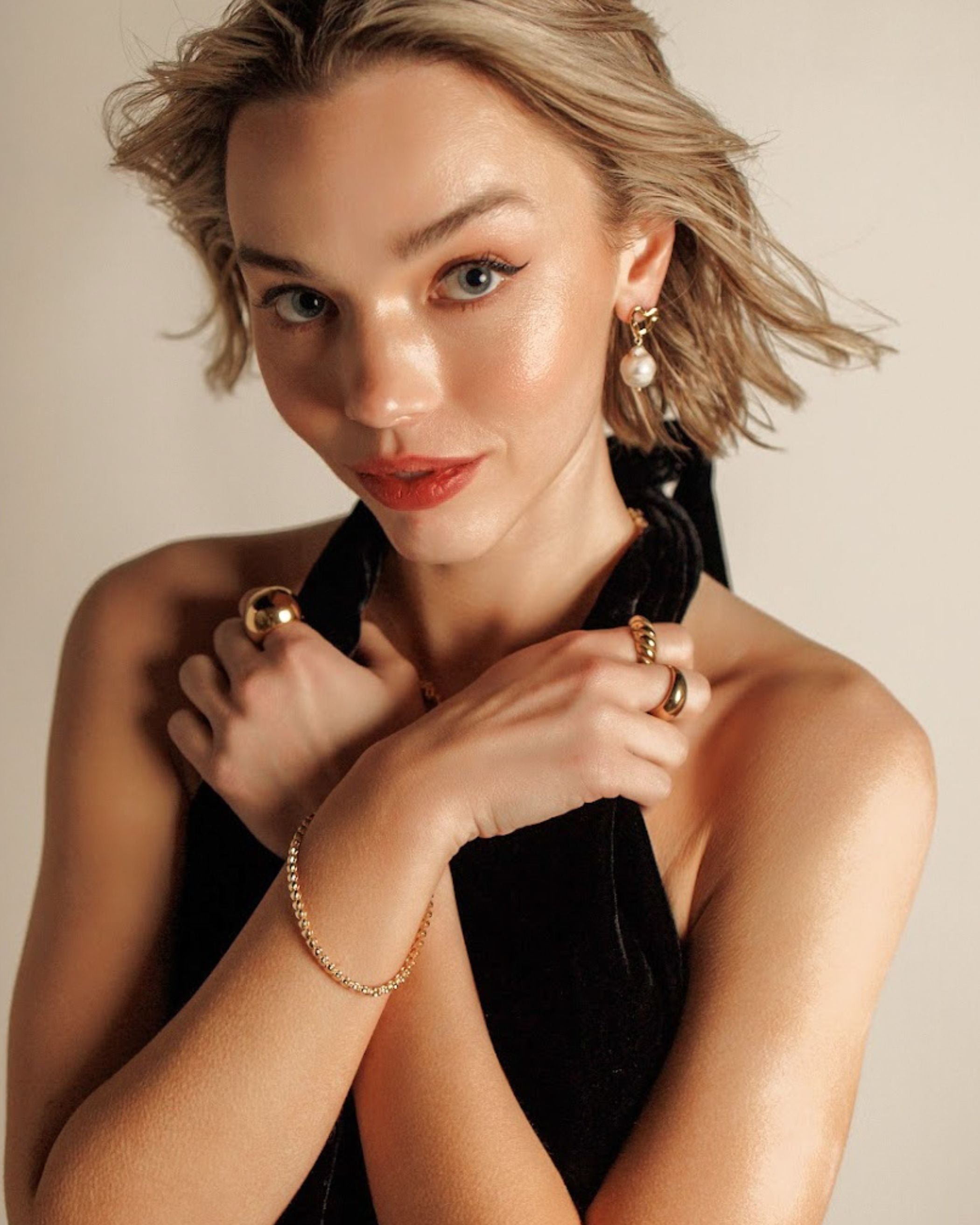 Model wearing Freya Earrings with pearl drop clearly visible.