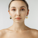 Elegant look with Giselle Earrings featuring gold and silver hearts.