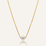 Ina Necklace featuring a gold chain with a single pearl pendant.