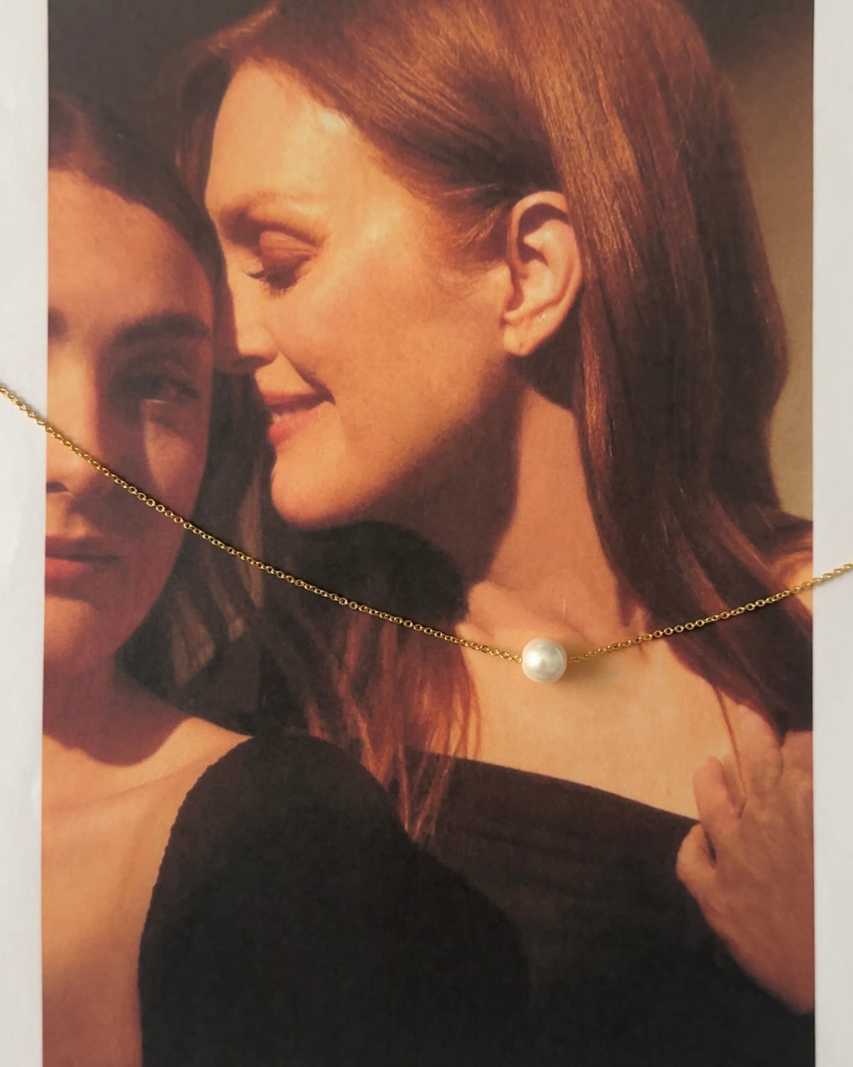 Ina Necklace worn alone on model’s neck with delicate gold chain and pearl.