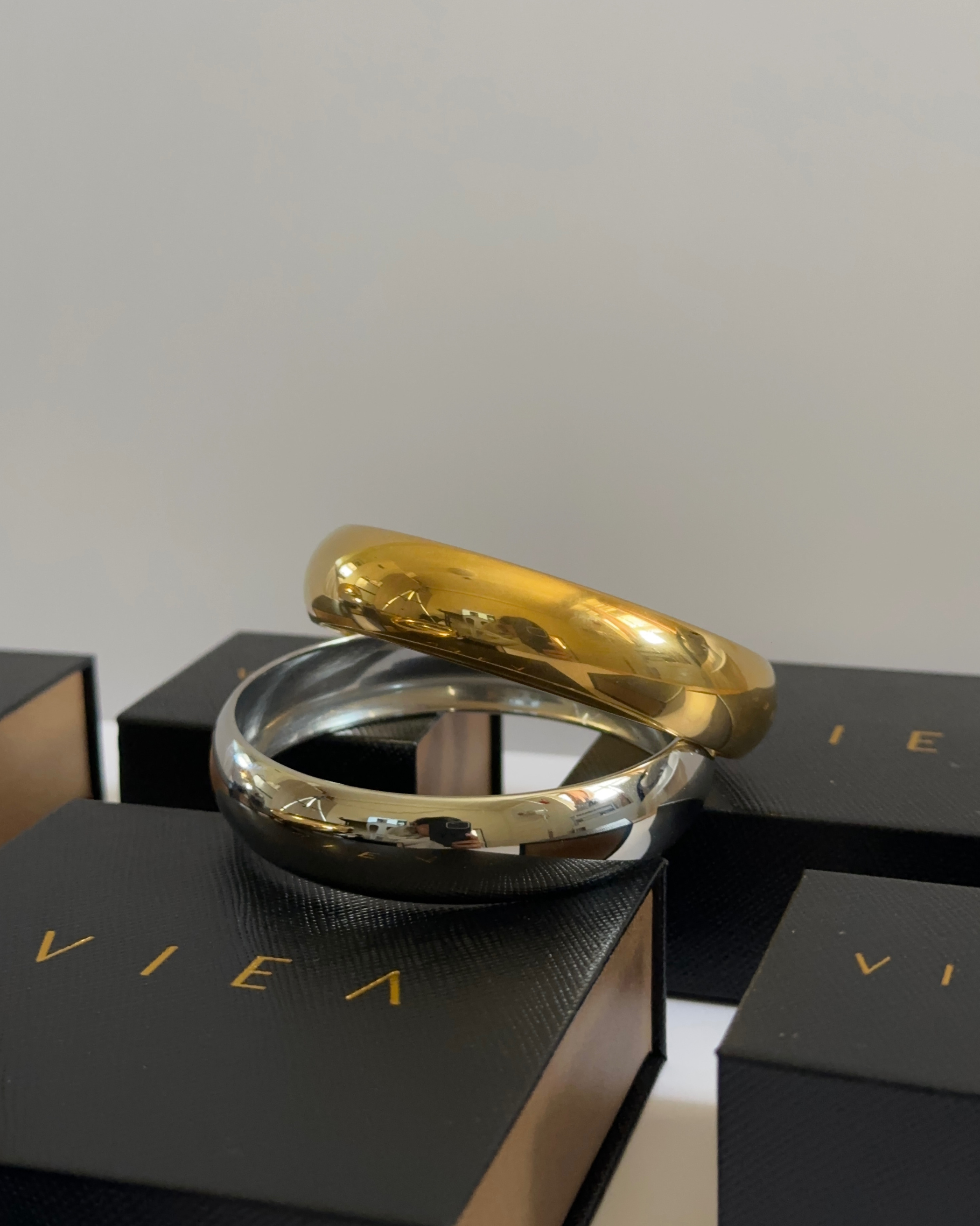 Kali Cuffs in silver and gold stacked together on VIEA Jewelry packaging.