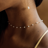 Closeup of the Layla Necklace worn, highlighting pearl and gold link pattern.