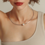 Model wearing the Loreli Choker in silver with a pearl centerpiece, showcasing its elegant, minimal style.