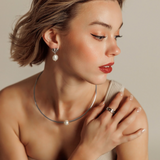 Side view of Loreli Choker showing its sleek silver finish and refined pearl detail on a model.