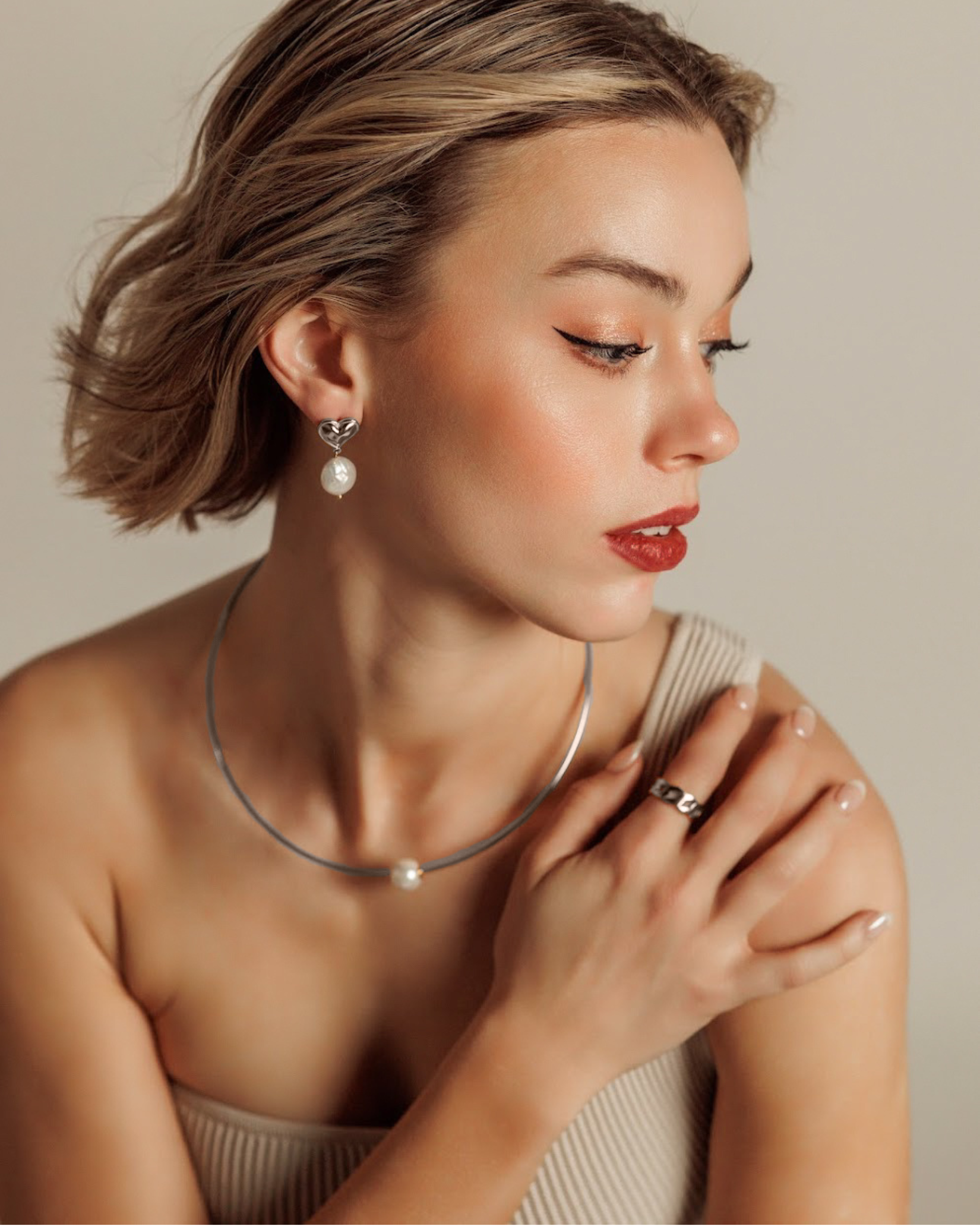 Side view of Loreli Choker showing its sleek silver finish and refined pearl detail on a model.