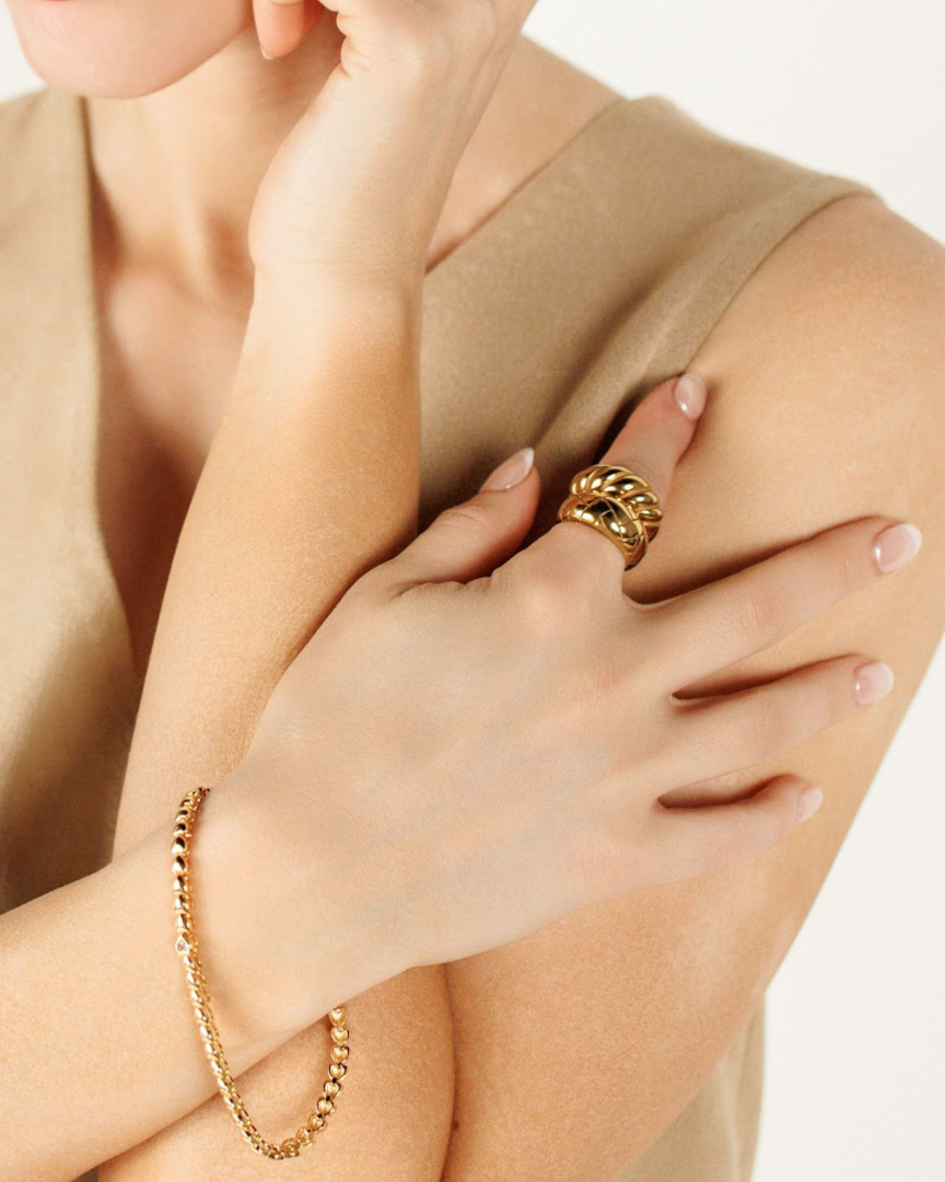 Love Bracelet styled with a brown sleeveless top, showing its versatility as a daily statement piece.