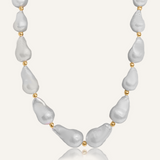 Product flatlay of the Margaret Necklace showcasing baroque pearls and gold bead accents.