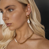Side view of Maya Earrings styled on model, showing baroque pearl drop detail.