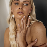 Portrait of model wearing Maya Earrings styled with full pearl drop for statement look.