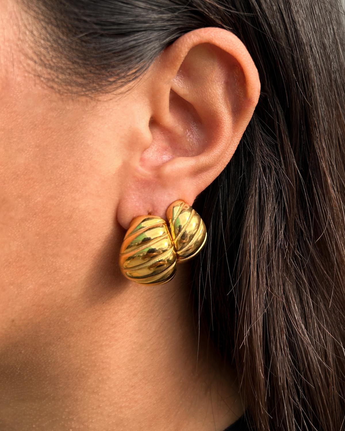 Model styling the Mini Demi Earrings for a chic Parisian look.