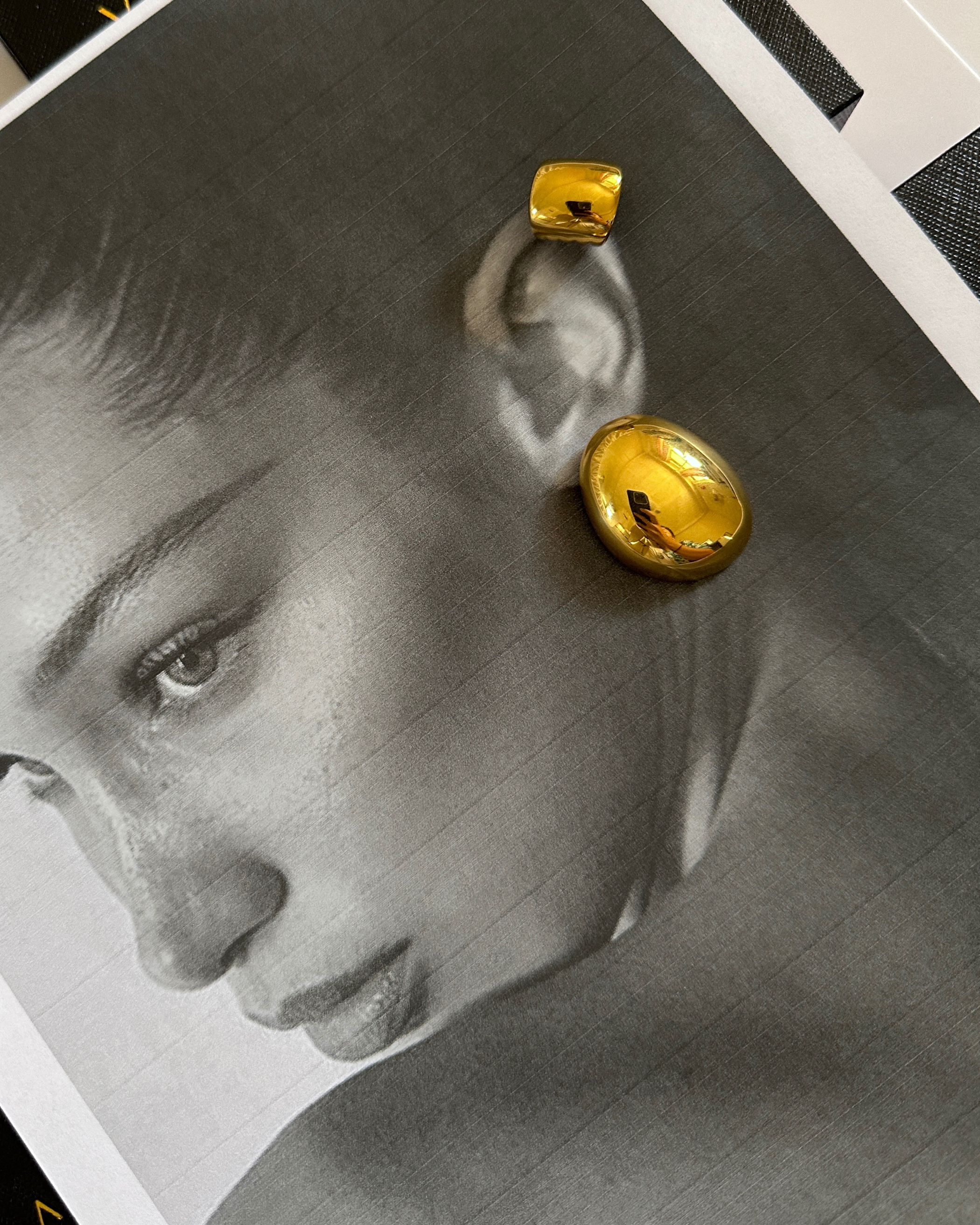 Model wearing Mona Gold Earrings showing off their artistic dome shape.