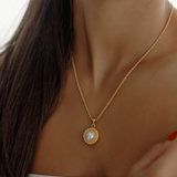 Close-up of the Myrcella Necklace worn on neck, highlighting pearl pendant detail.