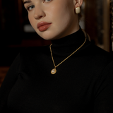 Model wearing the Myrcella Necklace styled as a minimalist pearl statement piece.