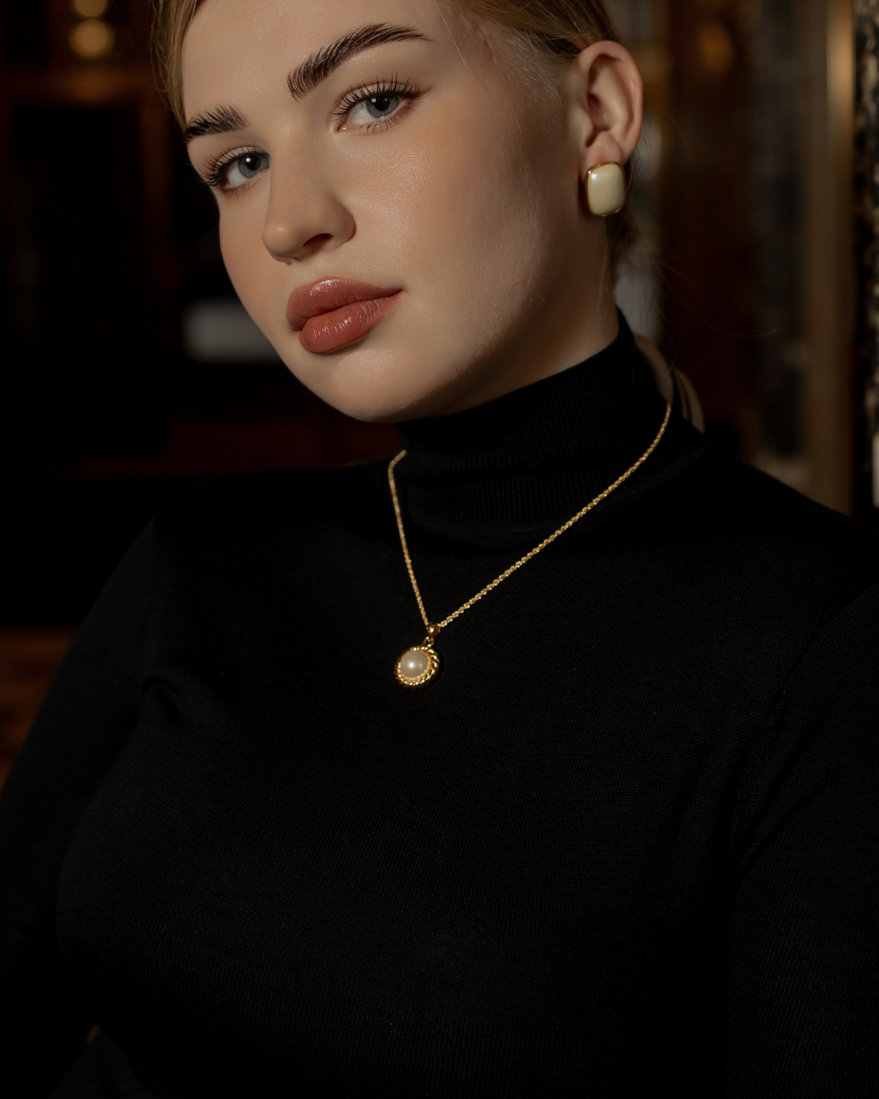 Model wearing the Myrcella Necklace styled as a minimalist pearl statement piece.