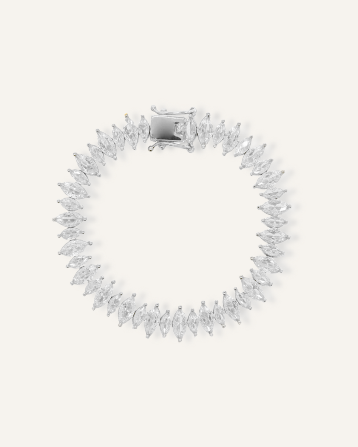 Flatlay of Naomi Bracelet in silver with horse eye zirconia stones and tennis chain design.
