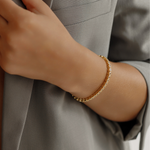 18K gold Zara Bracelet worn as a daily piece featuring square-cut zirconia stones.