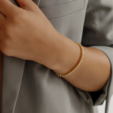 18K gold Zara Bracelet worn as a daily piece featuring square-cut zirconia stones.