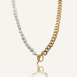 Flatlay image of Blanche Necklace with half gold curb chain and half freshwater pearls.