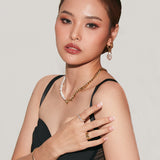 Semi side view of Blanche Necklace styled on a model with both gold and pearl sides visible.