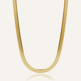 Flatlay of Capri Necklace showing its bold gold herringbone chain design.