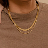 Closeup of Capri Necklace worn to highlight its thick and sleek gold chain texture.