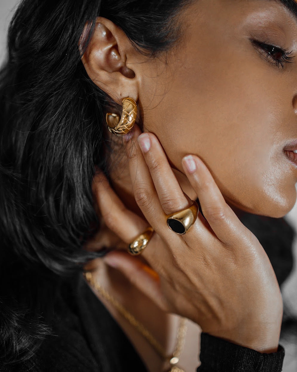 Side angle closeup of Gaia Earrings worn to display the curved semi-hoop profile.