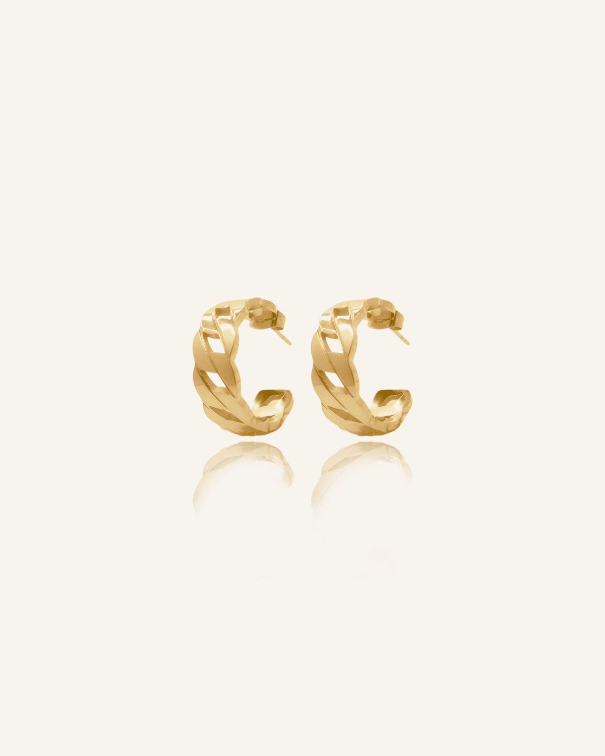 Product flatlay of Kalani Earrings showing gold Cuban link huggie design.