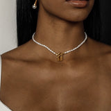 Closeup view of the Lily Necklace on neck highlighting padlock pendant and pearl choker design.