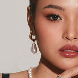 Half-face view of model wearing Maya Earrings with pearl attachment.