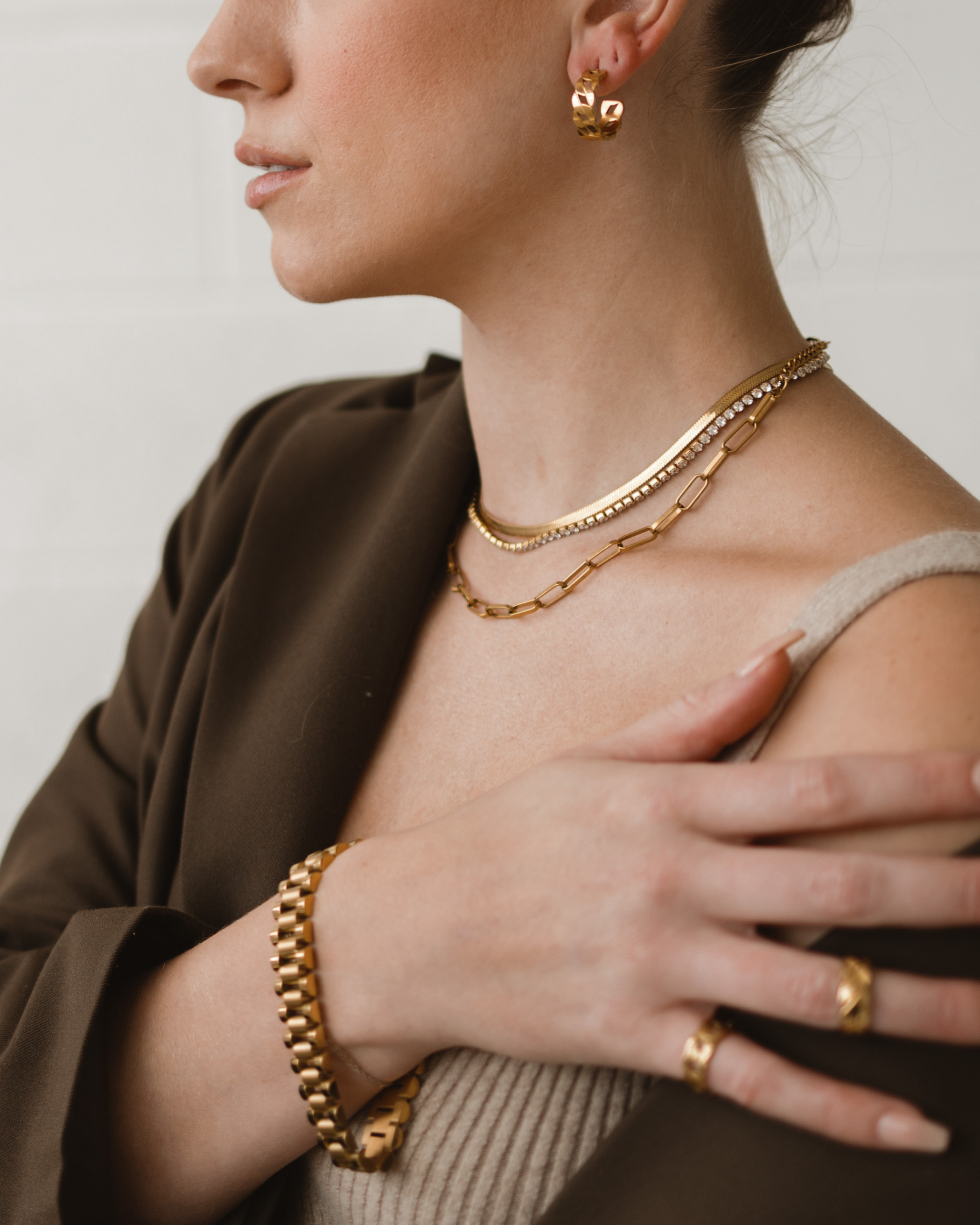 Side angle of Zain gold bracelet showing elegant and sleek 10mm thickness.