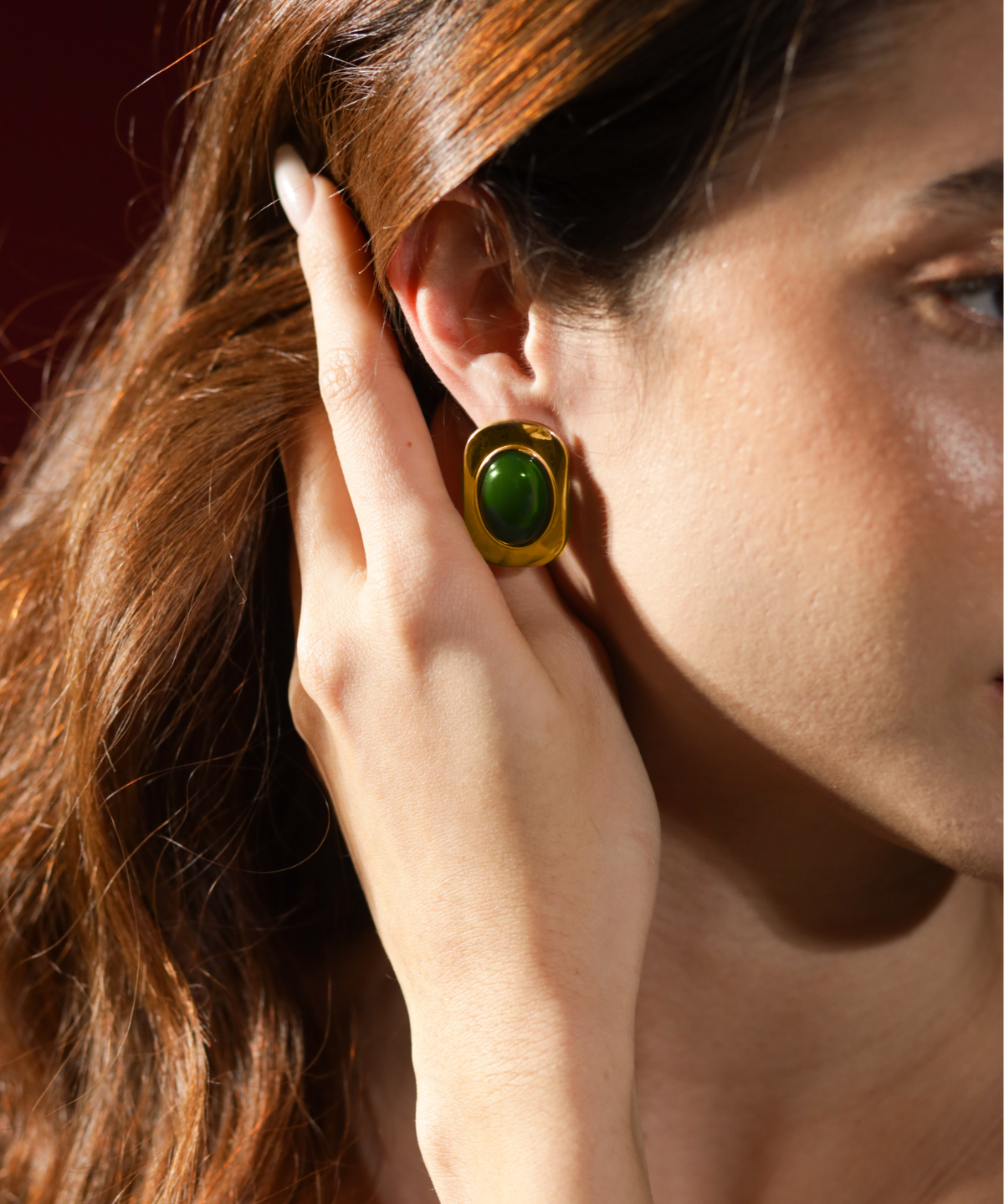 Close-up of Aina Earrings worn, highlighting green opal detail and gold finish.