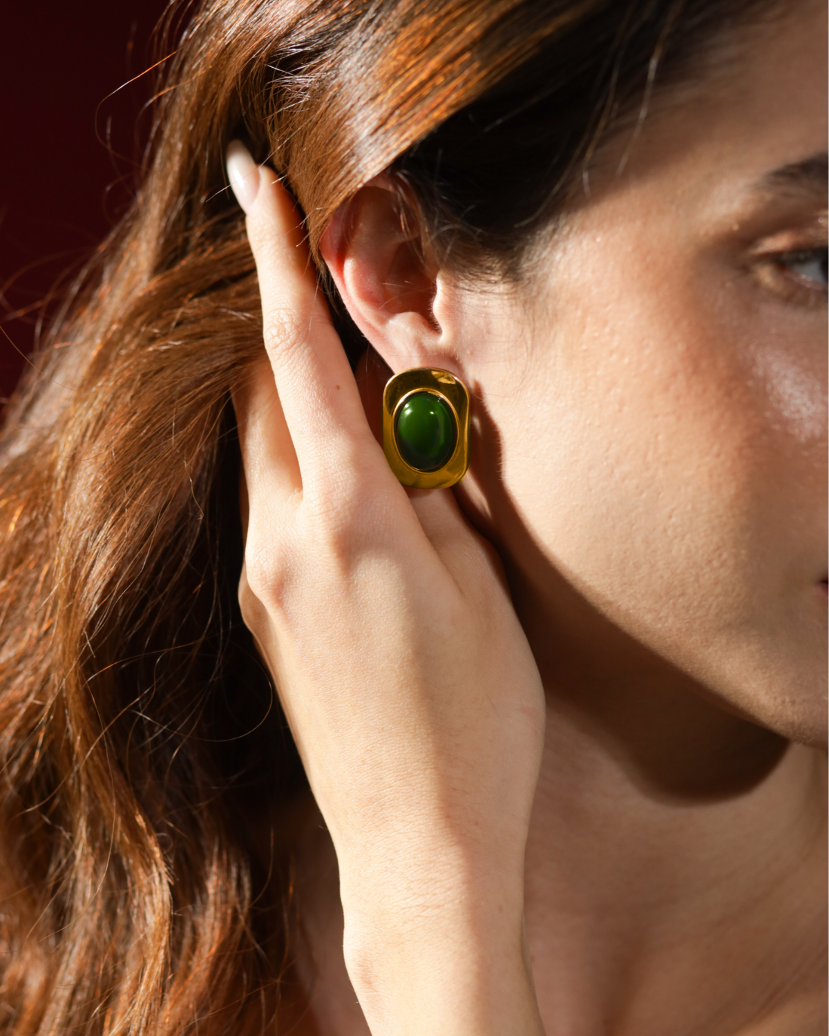 Close-up of Aina Earrings worn, highlighting green opal detail and gold finish.