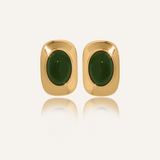 Flat lay of Aina Earrings featuring 18k gold coating and deep green opal stones.
