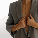 18K gold Andra Bracelet paired with other minimal jewelry for a sophisticated look.