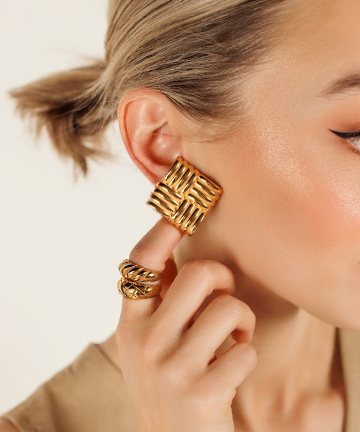 Close-up of Asha Earrings worn, showcasing intricate gold detailing and secure push-back lock.