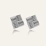 Flatlay of Asha Earrings in silver, showing woven texture and elegant round drop design.