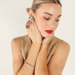 Side profile of model showcasing the Asha silver earrings as bold, everyday statement pieces.