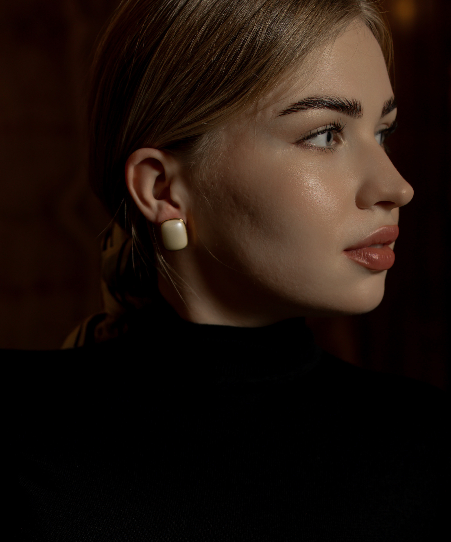 Close-up of Blaire Earrings worn, showcasing pearl detail and gold finish.