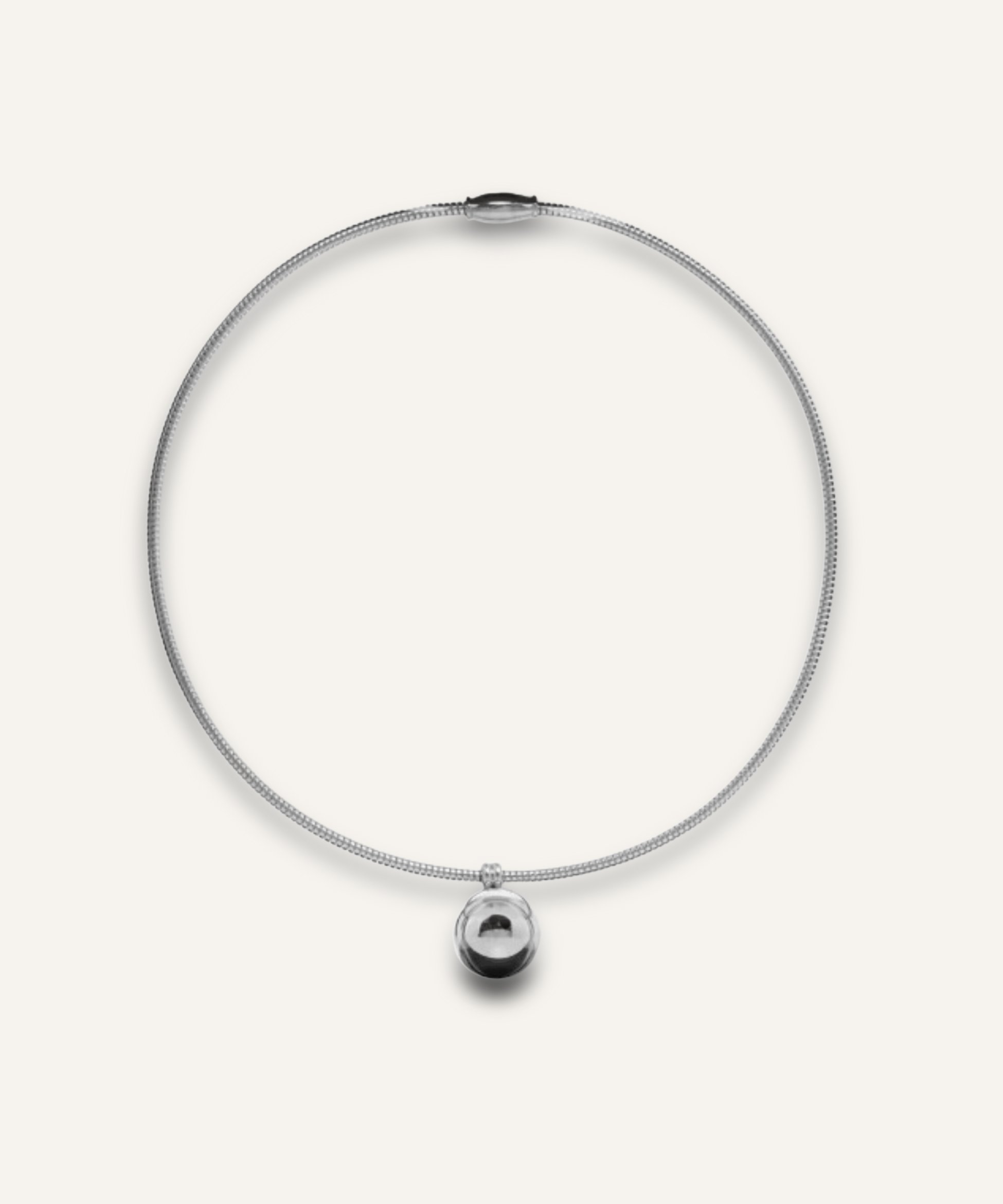 Casie Necklace in silver featuring a round snake chain with a bold circular dome pendant.