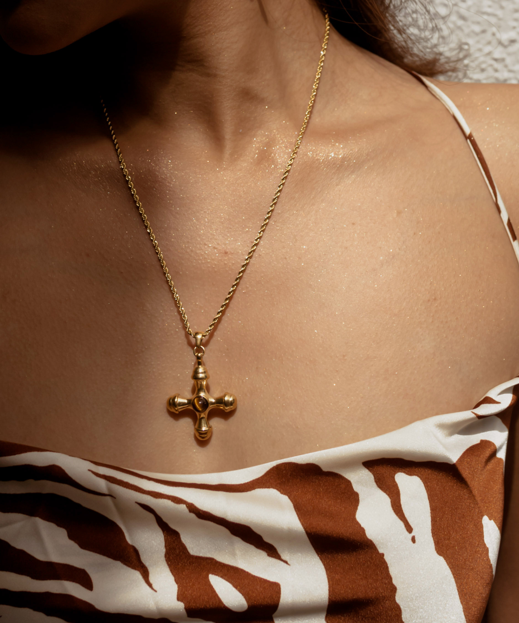 Closeup of model wearing Chiara Necklace with tiger eye cross pendant.