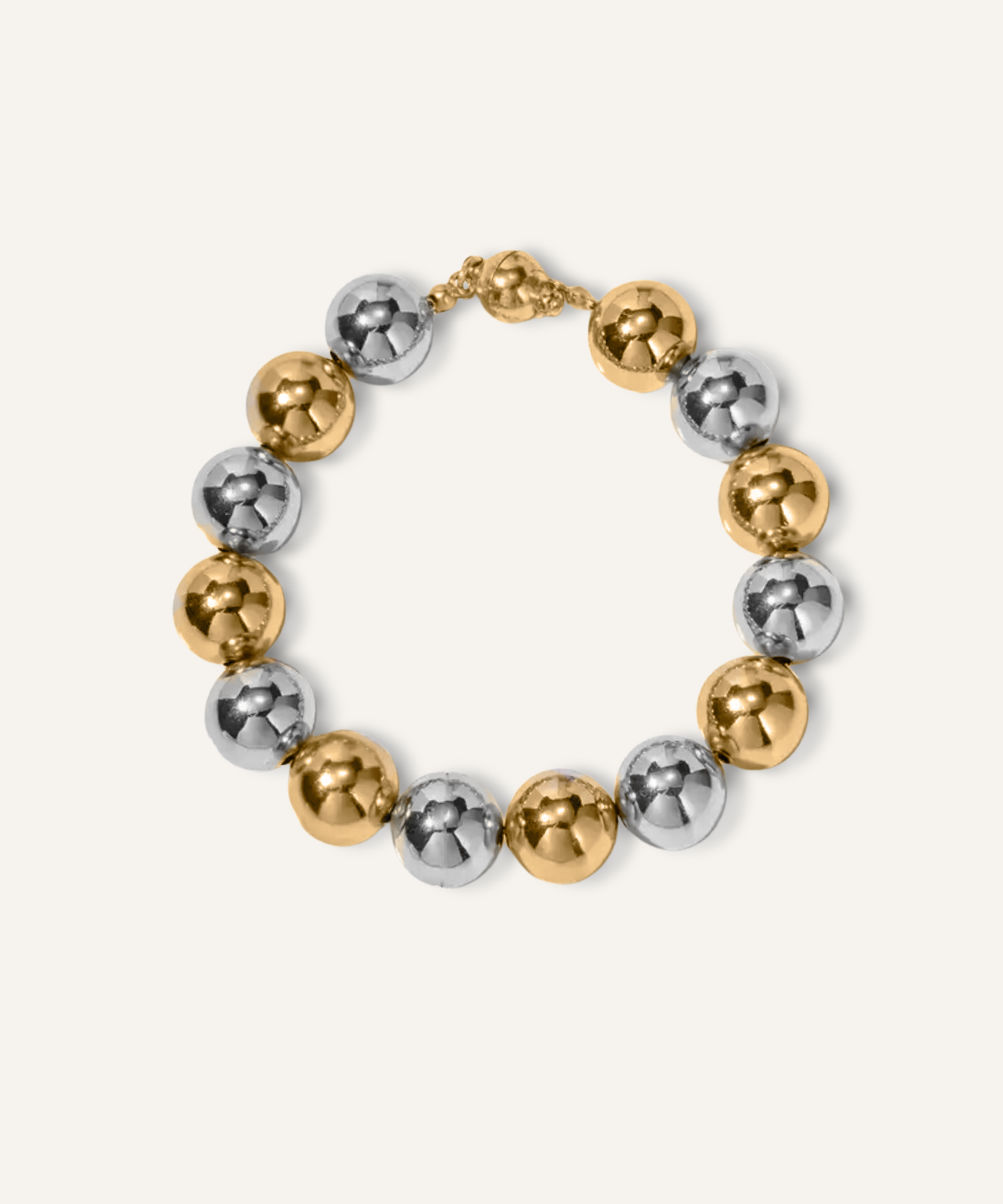 Cleo Bracelet with gold and silver beads displayed on a white surface.