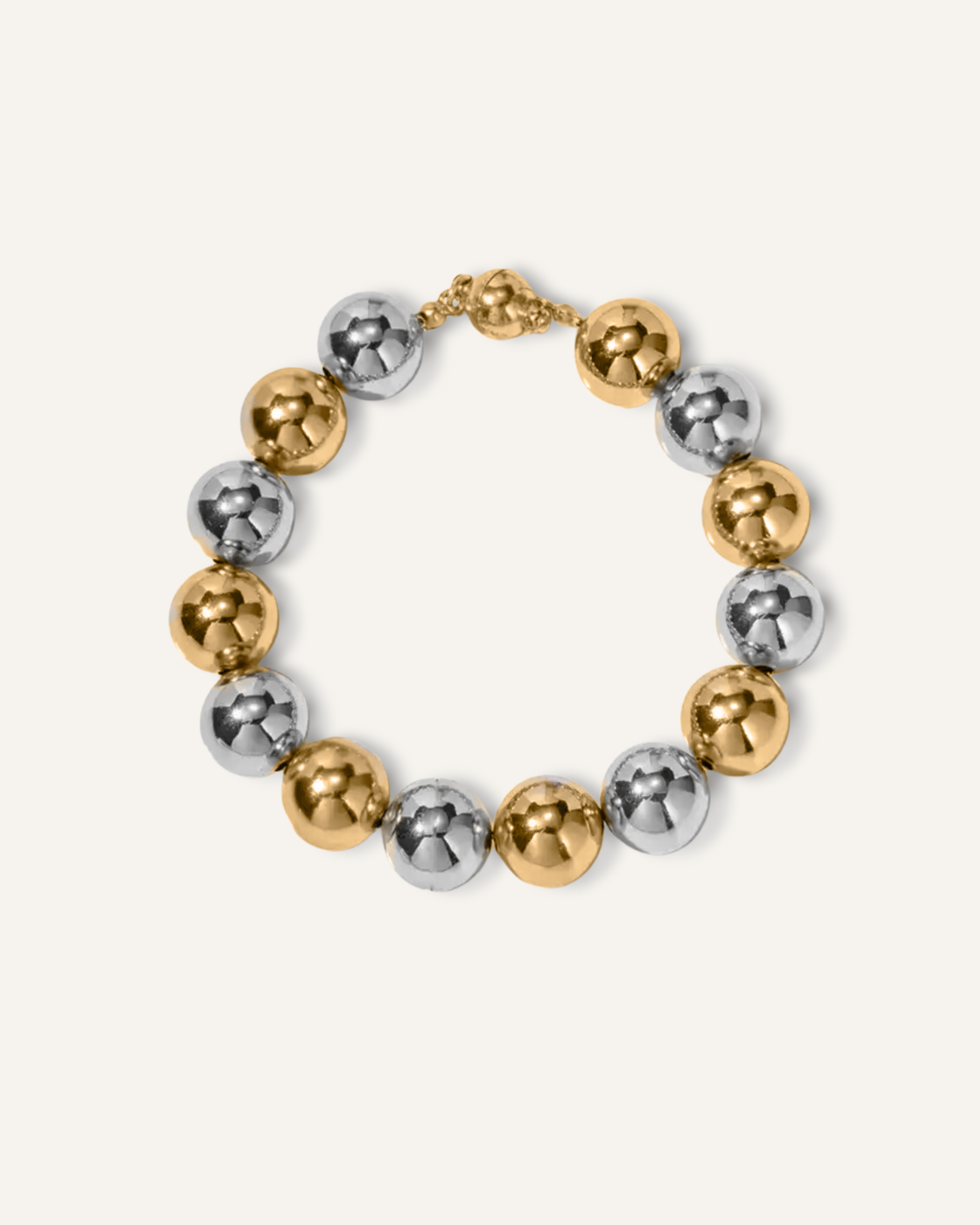 Cleo Bracelet with gold and silver beads displayed on a white surface.