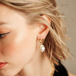 Close-up of Freya Earrings worn, showing baroque pearl and gold details.