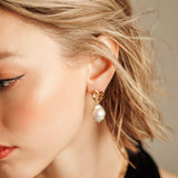 Close-up of Freya Earrings worn, showing baroque pearl and gold details.