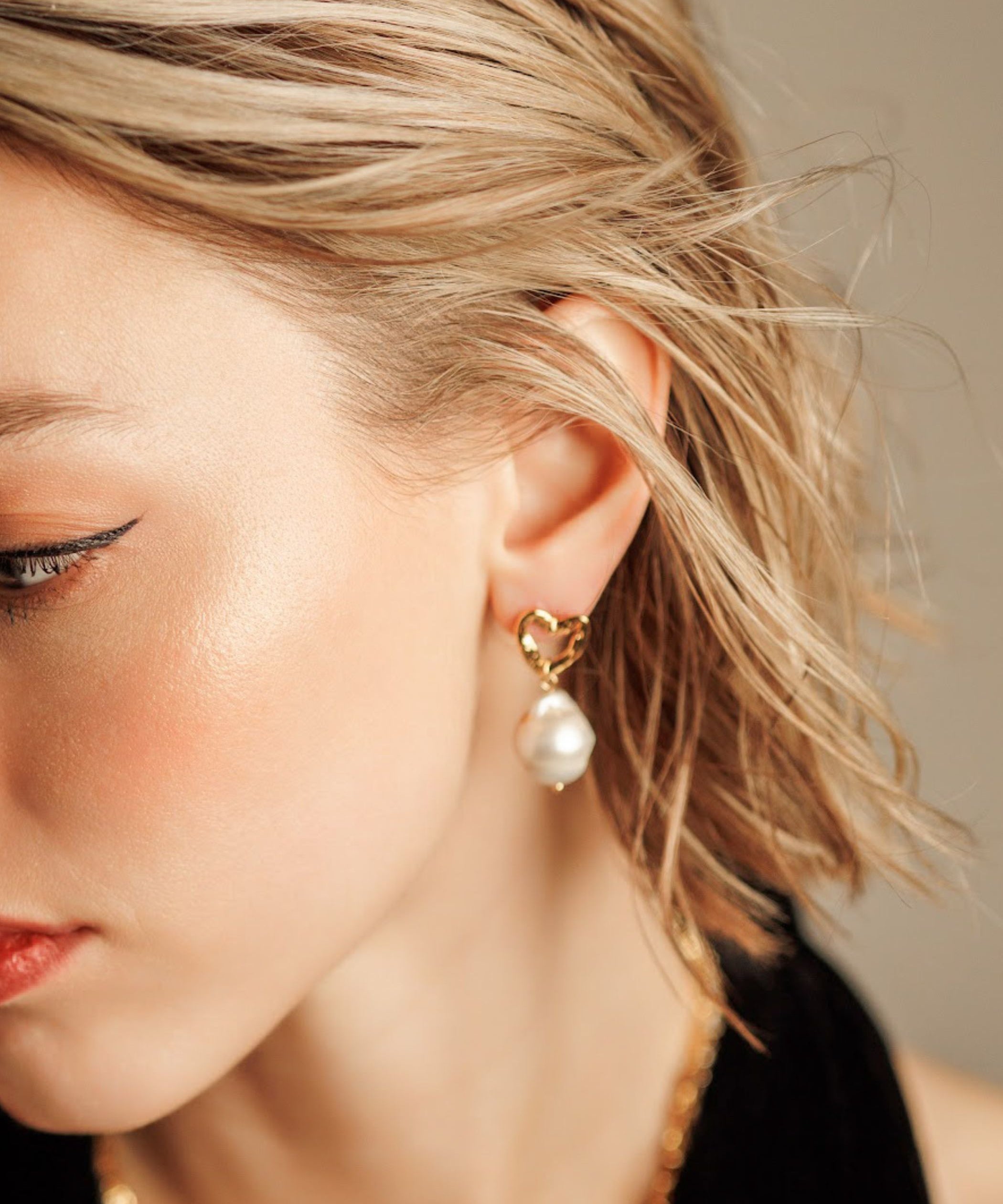 Close-up of Freya Earrings worn, showing baroque pearl and gold details.
