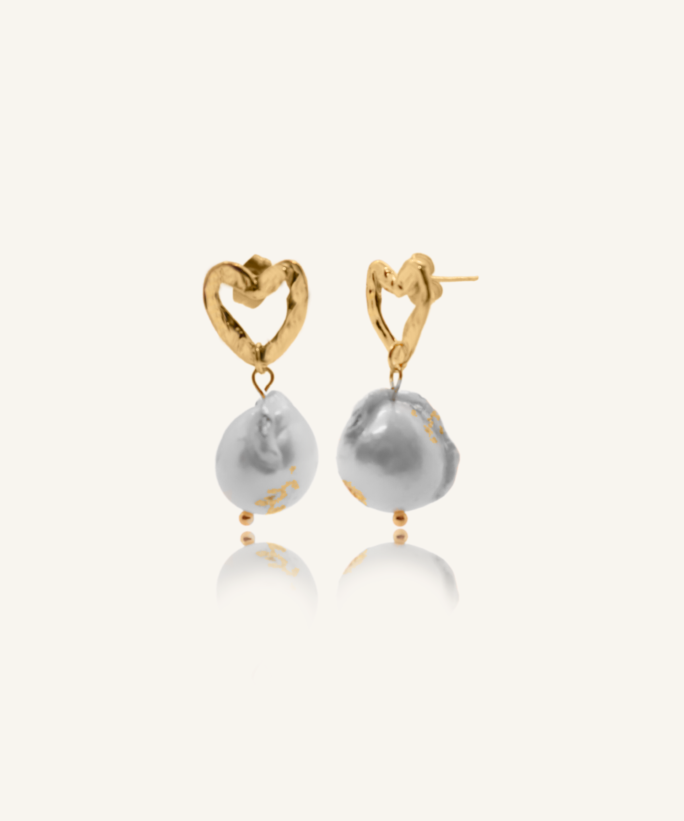 Freya heart-shaped gold earrings with unique baroque pearl and gold flaking.