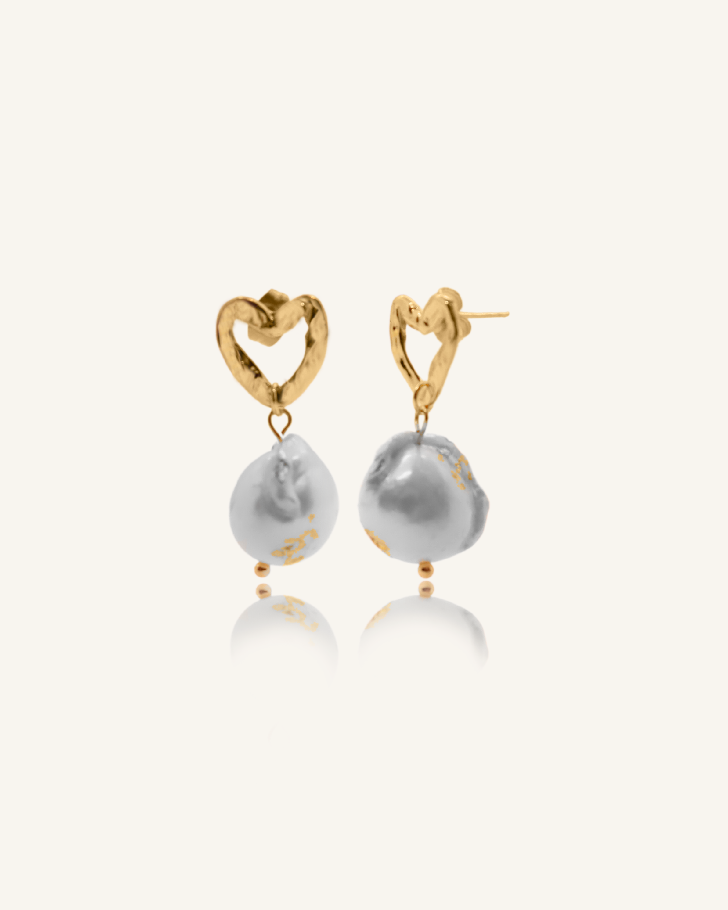 Freya heart-shaped gold earrings with unique baroque pearl and gold flaking.