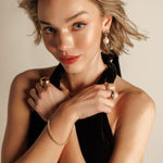 Model wearing Freya Earrings with pearl drop clearly visible.